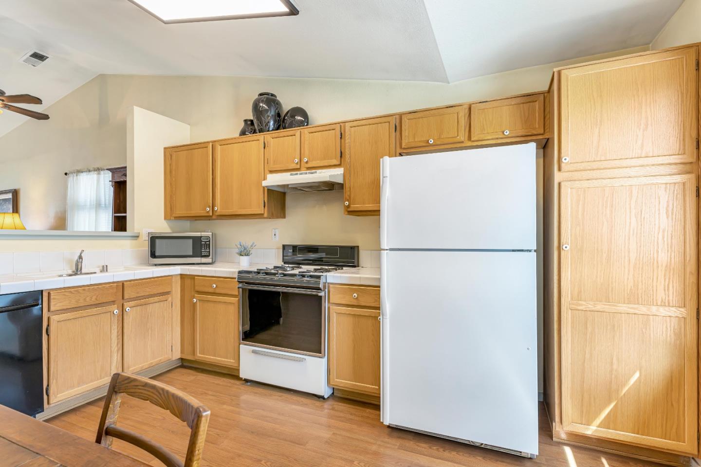 440 Meyer Circle Gonzales, CA 93926 - Photo 14 of 45 a kitchen with appliances a refrigerator and a sink