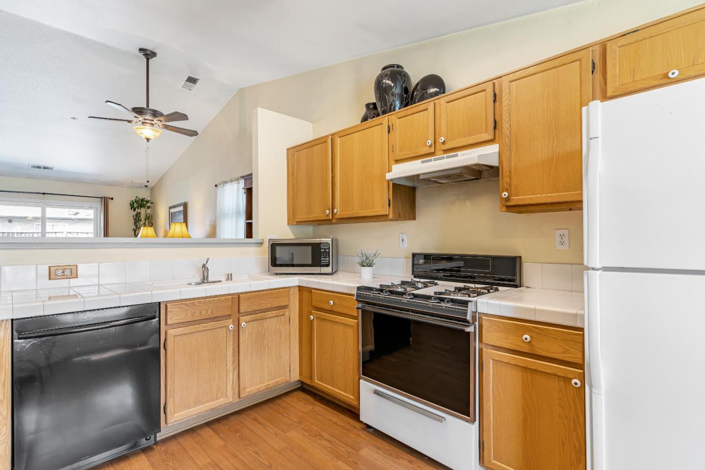 440 Meyer Circle Gonzales, CA 93926 - Photo 17 of 45 a kitchen with stainless steel appliances a stove a sink and white cabinets