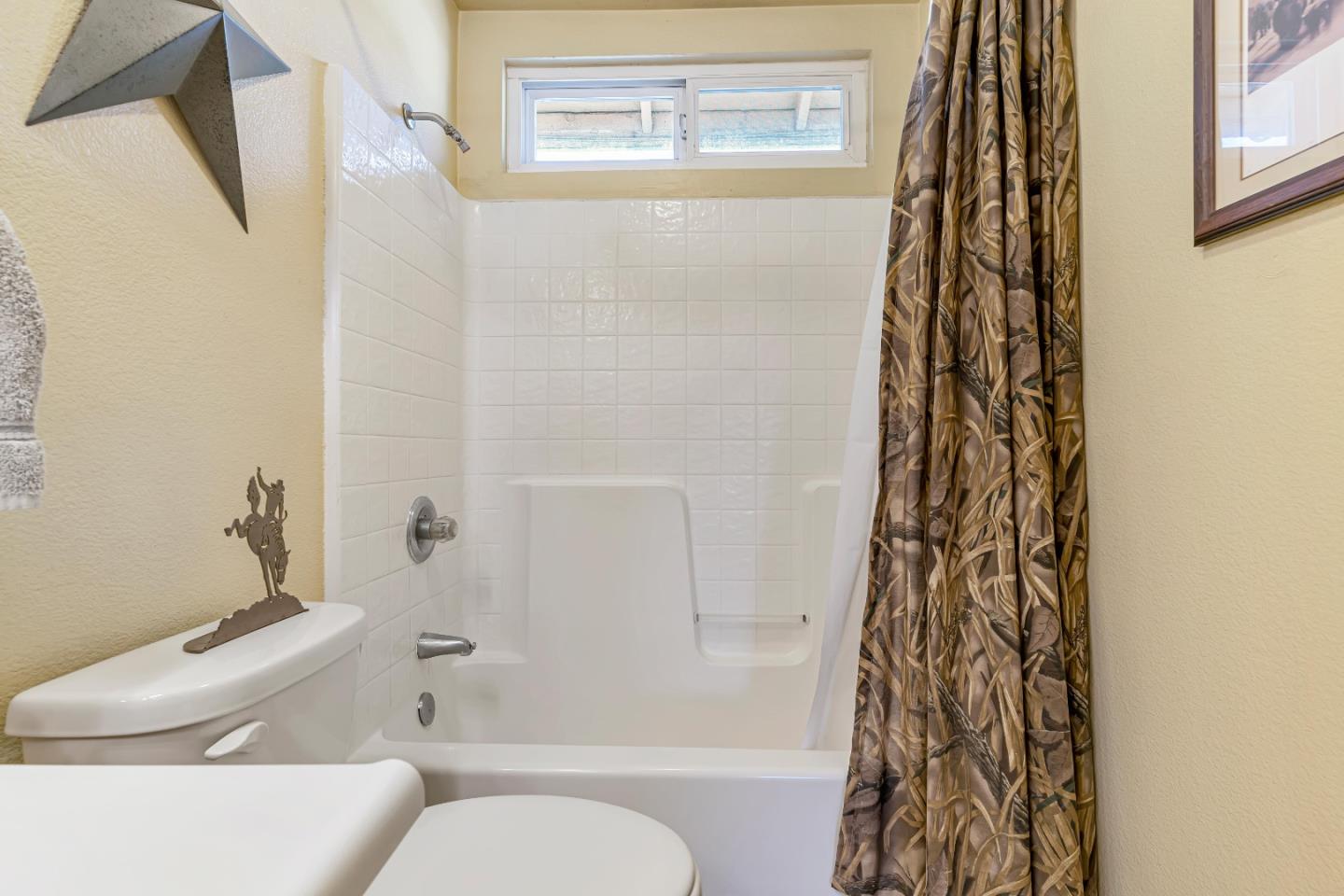 440 Meyer Circle Gonzales, CA 93926 - Photo 34 of 45 a bathroom with a toilet and a shower curtain