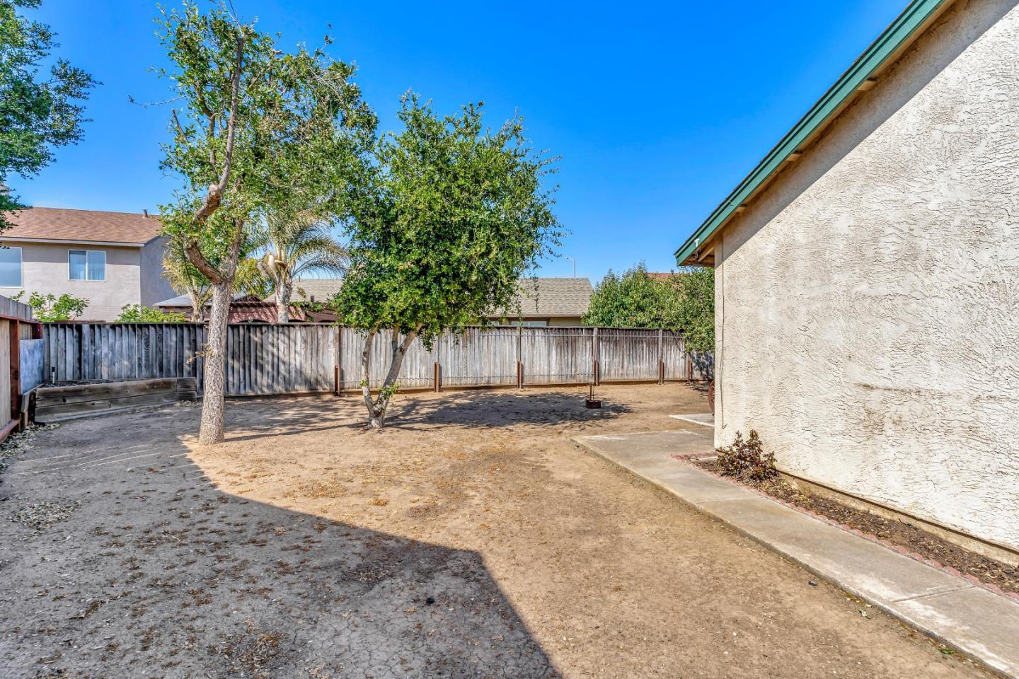 440 Meyer Circle Gonzales, CA 93926 - Photo 44 of 45 a view of a backyard with wooden fence and a large tree