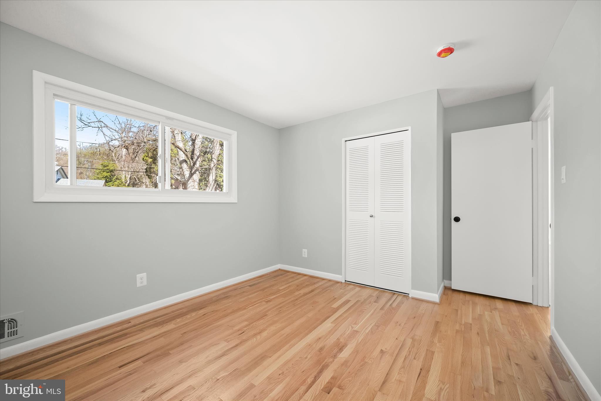 9720 Hedin Drive Silver Spring, MD 20903 - Photo 40 of 79 an empty room with wooden floor and windows