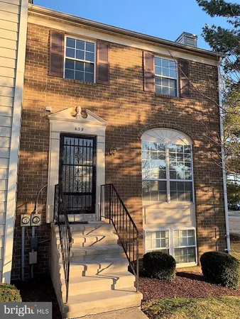 a view of a brick building next to a yard