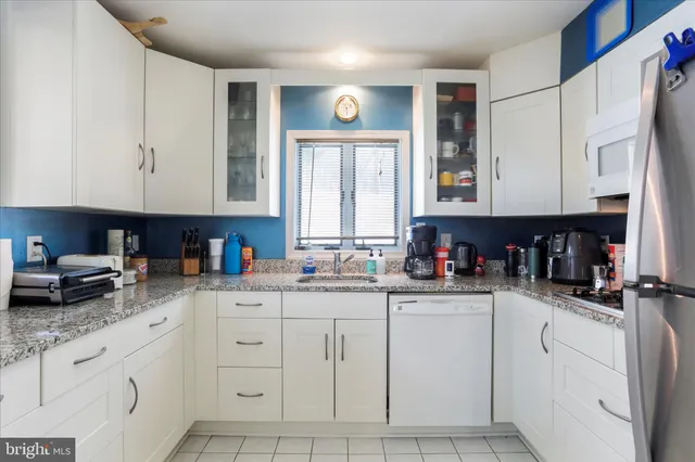 a kitchen with stainless steel appliances granite countertop a sink and cabinets