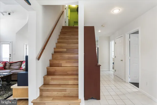 a view of an entryway with wooden floor and stairs