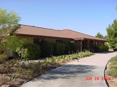 13947 Hopi Road Apple Valley, CA 92307 - Photo 1 of 1 a front view of house with yard and trees around