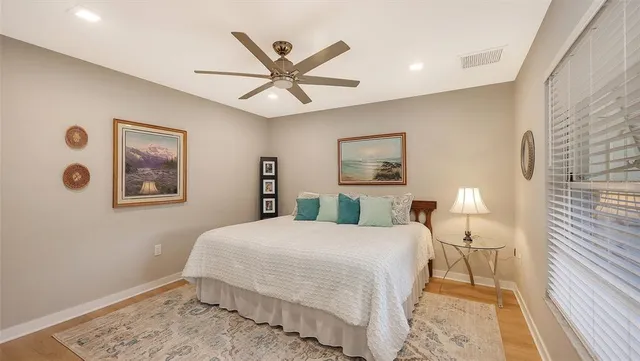 a bedroom with a bed and a window