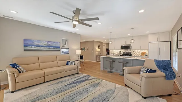a living room with furniture and kitchen view