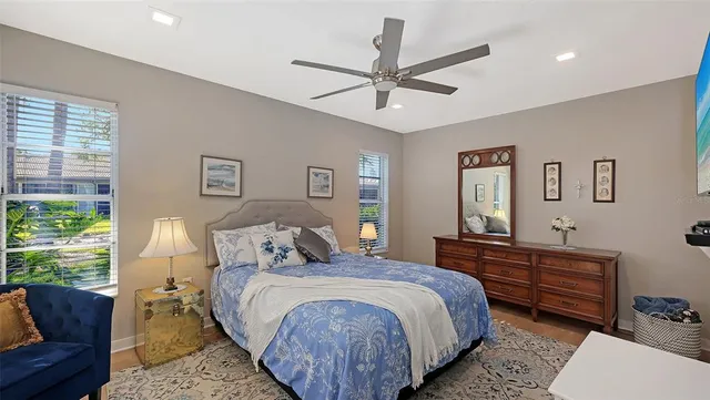 a bedroom with a bed a couch and a window