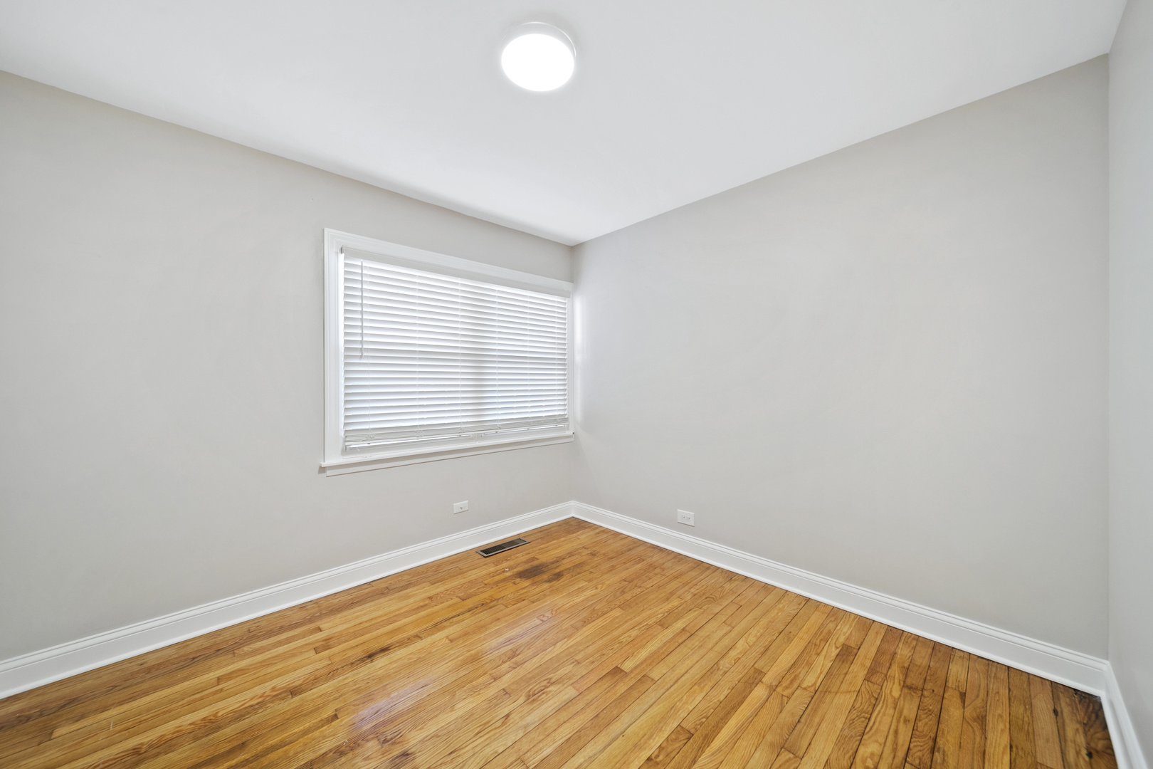 1601 Fowler Avenue Evanston, IL 60201 - Photo 24 of 33 an empty room with wooden floor and windows