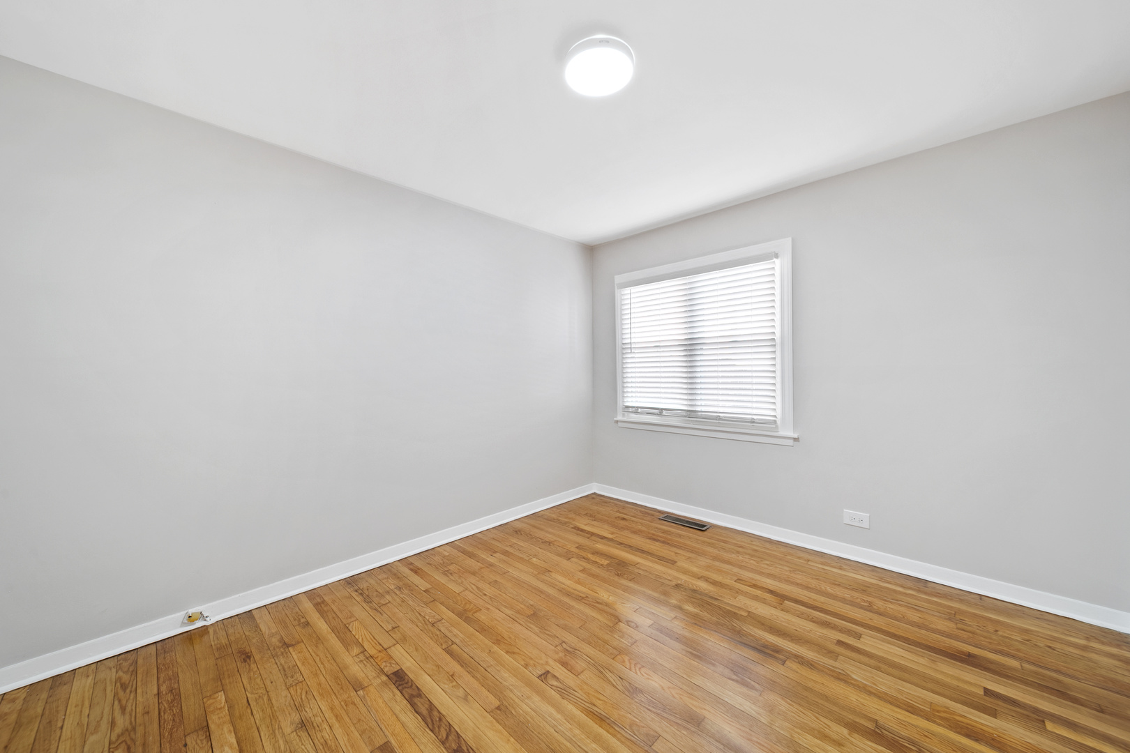1601 Fowler Avenue Evanston, IL 60201 - Photo 25 of 33 an empty room with wooden floor and windows