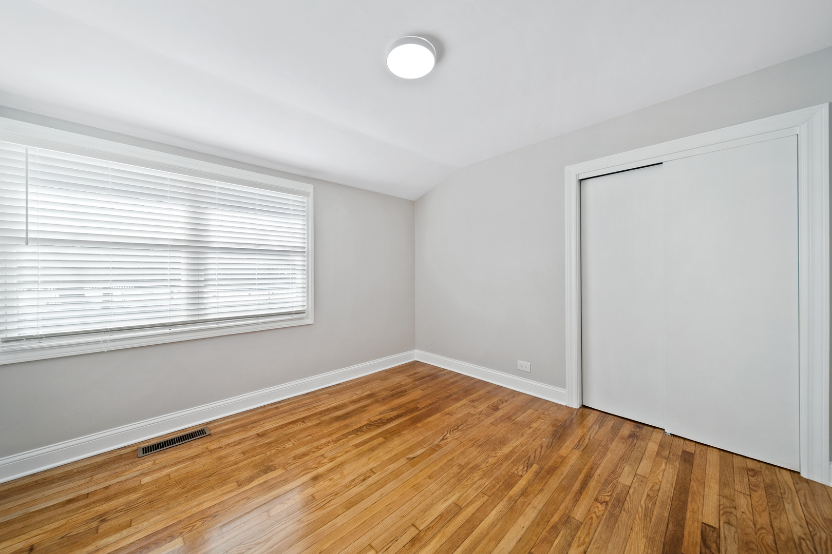 1601 Fowler Avenue Evanston, IL 60201 - Photo 8 of 33 an empty room with wooden floor and windows