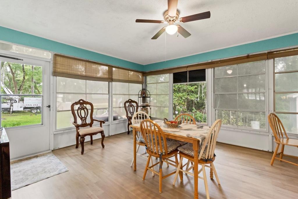 3550 South Dean Terrace Inverness, FL 34452 - Photo 26 of 37 a dining room with furniture a flat screen tv and a large window