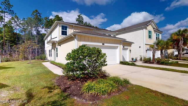 a front view of a house with garden