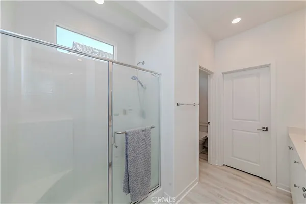 a bathroom with a shower and a glass door