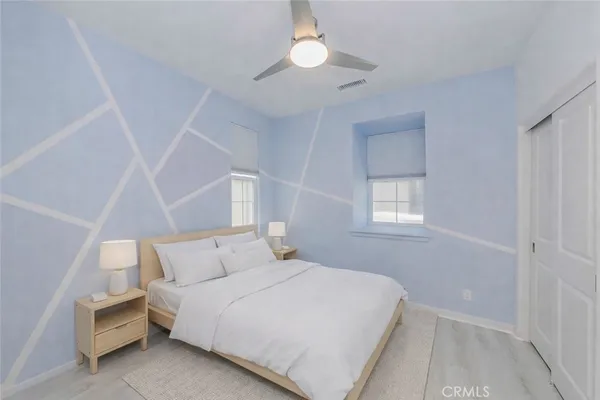 a bedroom with a bed and a chandelier