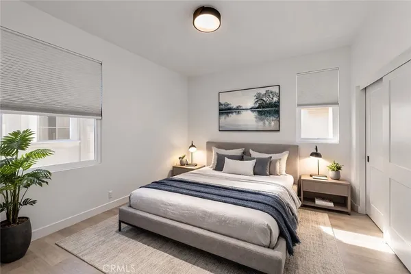 a bedroom with bed and a potted plant