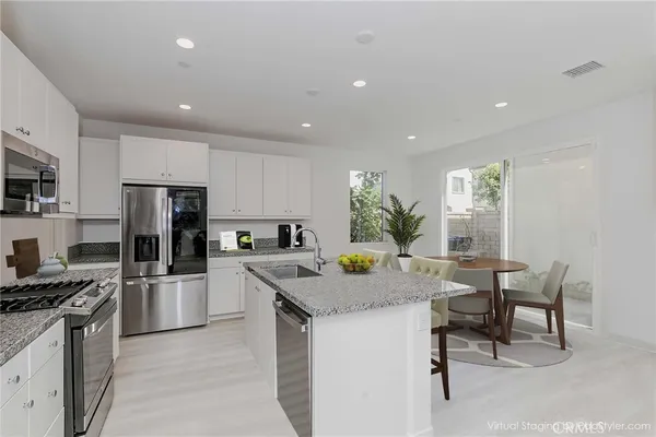 a kitchen with a stove a sink and a refrigerator