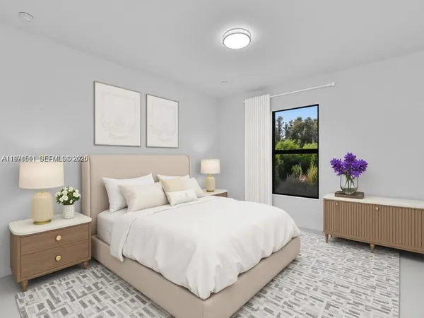 a bedroom with a large bed and a potted plant