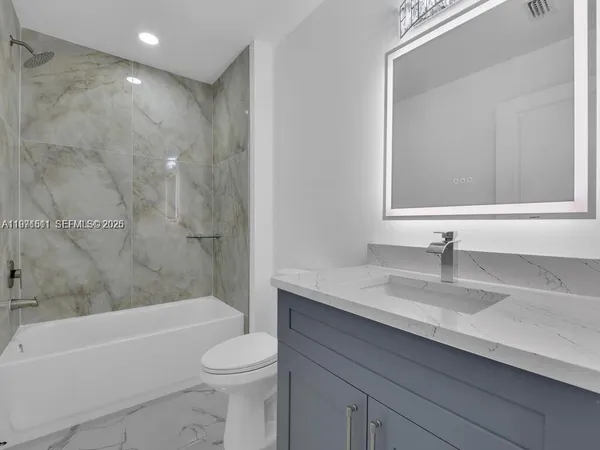 a bathroom with a sink a toilet and a bathtub