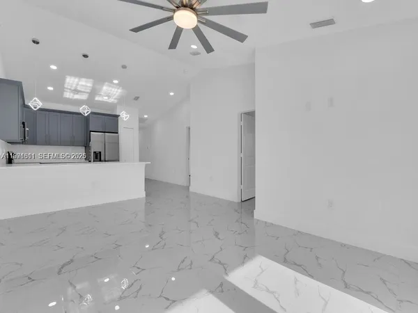 a view of a kitchen with a sink and chandelier
