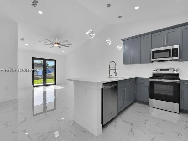 a kitchen with granite countertop a stove and a sink