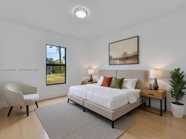 a bedroom with a bed and a potted plant