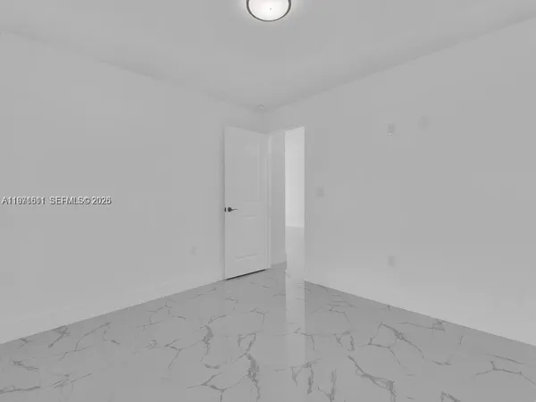 a view of empty room with ceiling fan