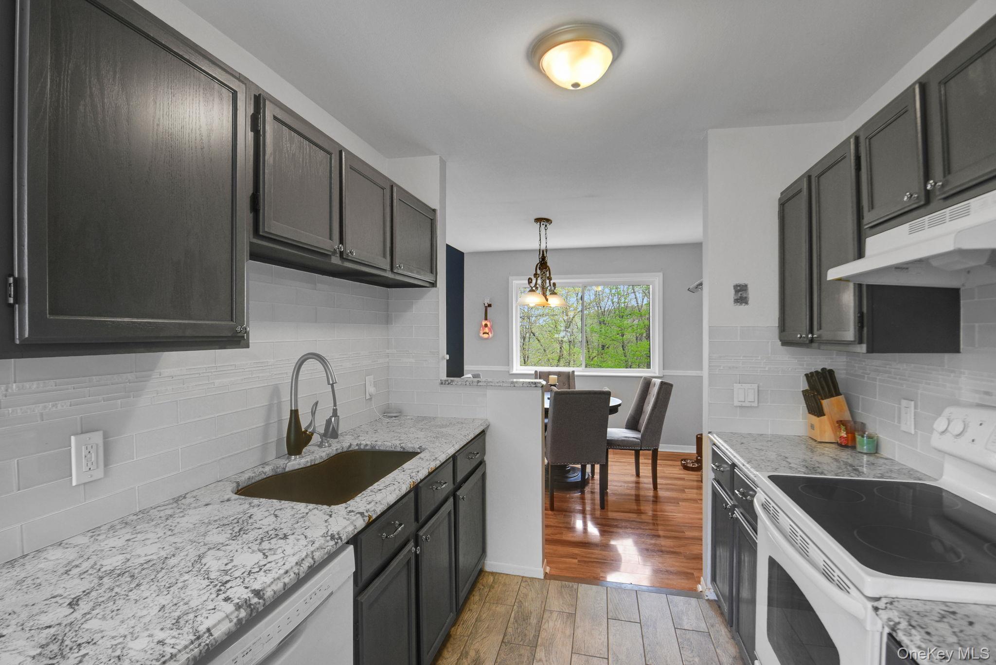805 Eagles Ridge Road Brewster, NY 10509 - Photo 8 of 22 a kitchen with granite countertop a sink a counter space appliances and cabinets