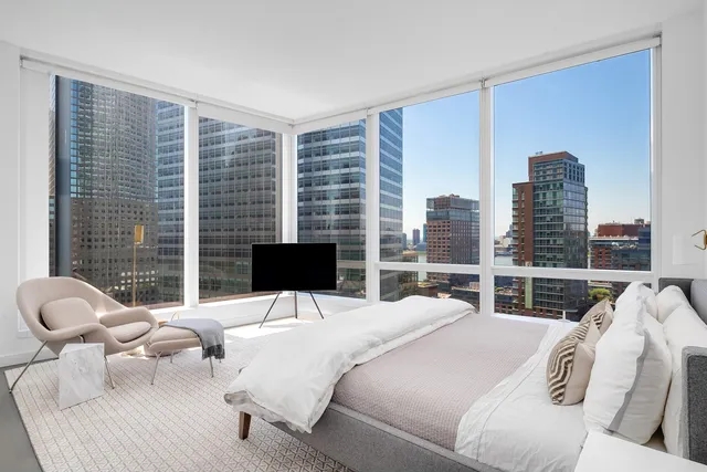 a bedroom with furniture and a large window