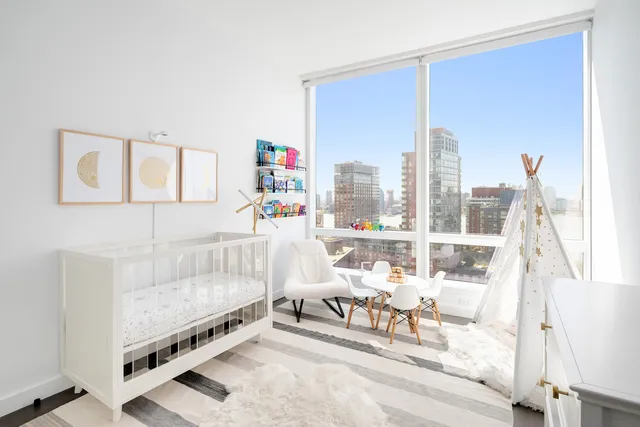 a living room with furniture and a floor to ceiling window