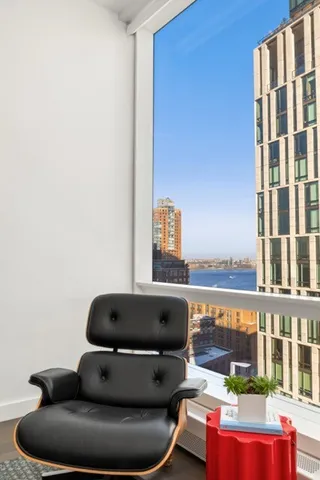 a room with furniture and a floor to ceiling window