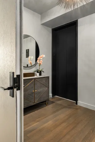 a view of a hallway with wooden floor
