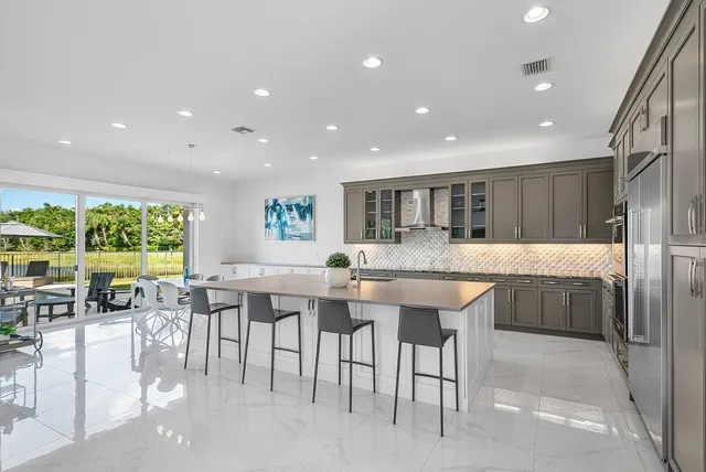 a view of a dining room with furniture large windows and wooden floor