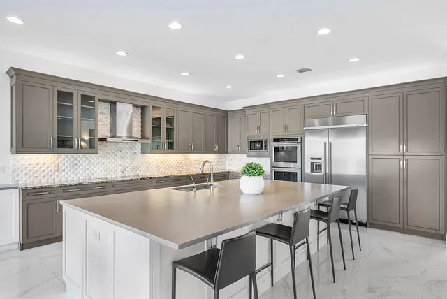 a kitchen with a sink and chairs