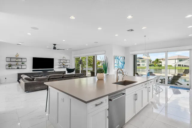 a large kitchen with stainless steel appliances kitchen island a large counter top and a stove