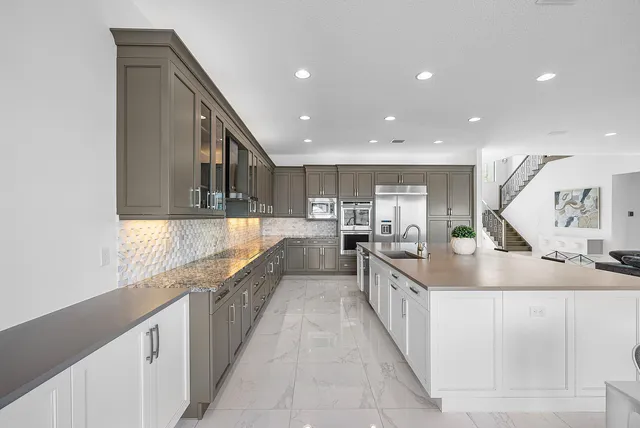 a bathroom with a sink a toilet a mirror a bathtub and shower