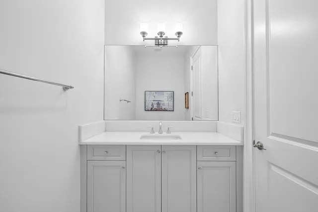 a bedroom with a bed a window and a potted plant