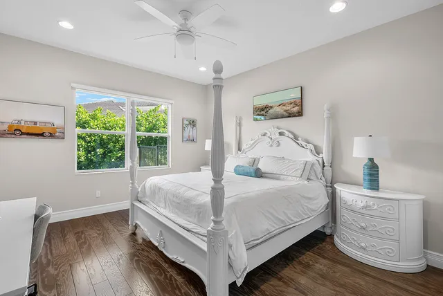 a view of a hallway with wooden floor and windows