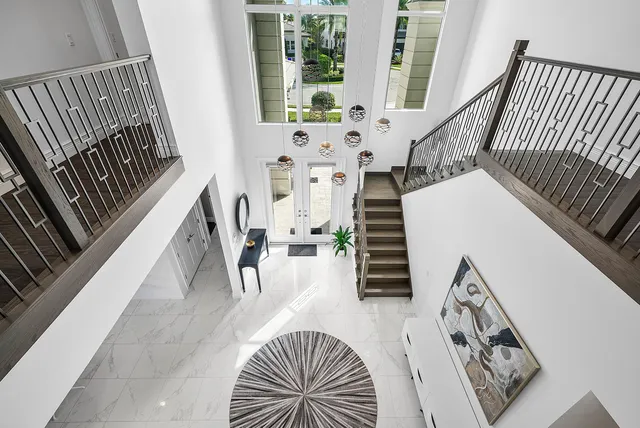 a living room with furniture a ceiling fan and a rug