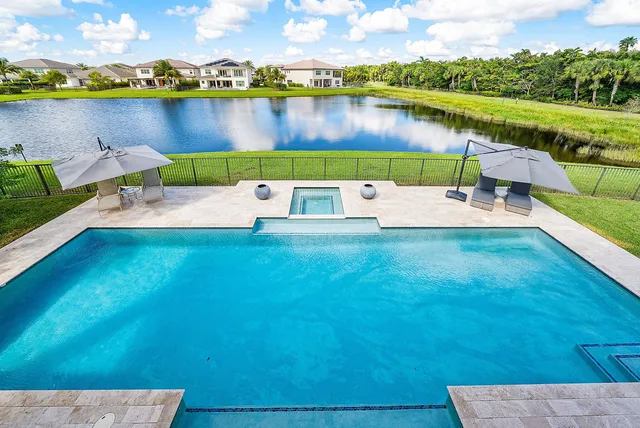 a bathroom with a granite countertop sink a toilet and a mirror