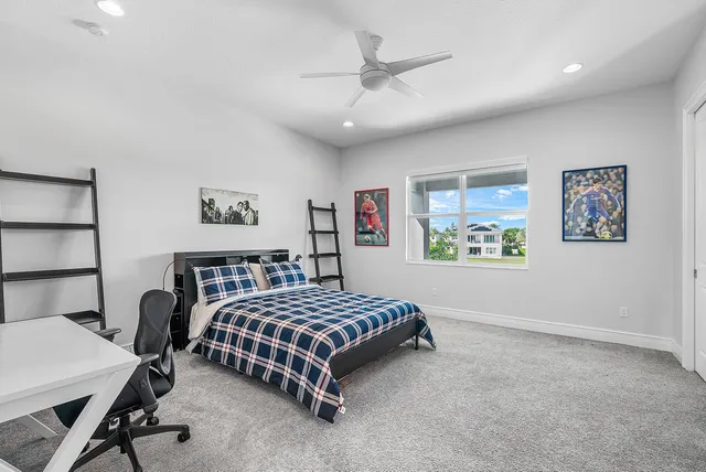an aerial view of a swimming pool with lawn chairs and large trees