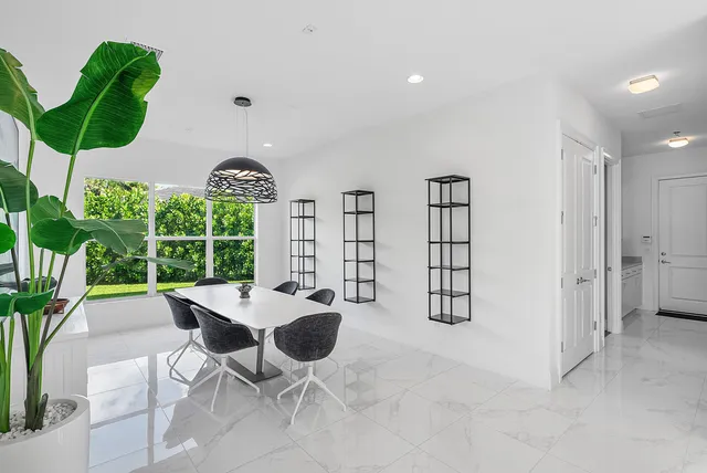 a view of a dining room with furniture and chandelier