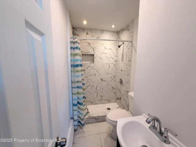 a bathroom with a toilet and shower