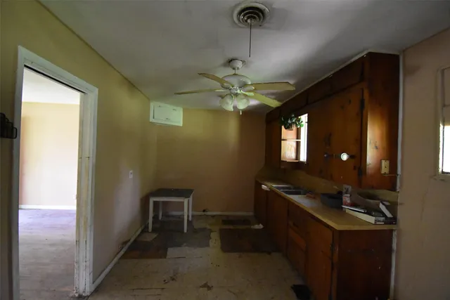 a view of a hallway with workspace and a window