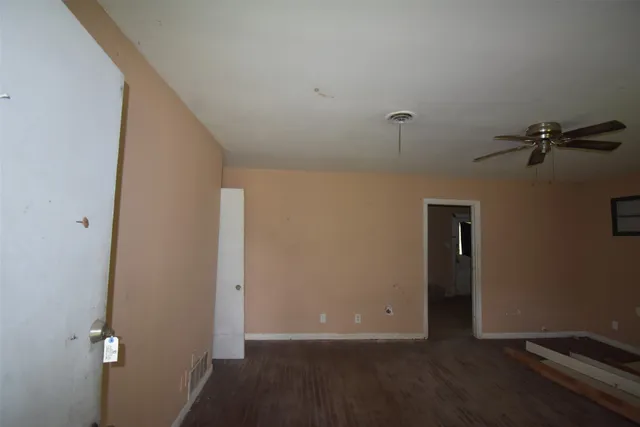 a view of a room with wooden floor