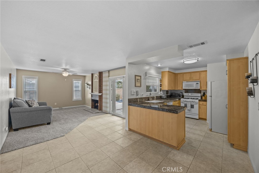 1763 Gleason Street Corona, CA 92882 - Photo 11 of 41 a kitchen with stainless steel appliances granite countertop a refrigerator and a sink