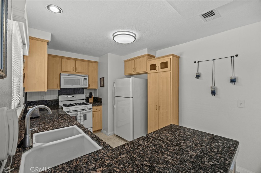 1763 Gleason Street Corona, CA 92882 - Photo 13 of 41 a kitchen with a refrigerator and a stove top oven