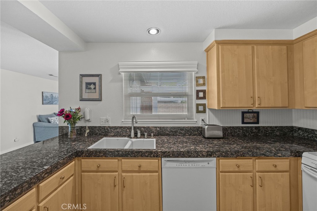 1763 Gleason Street Corona, CA 92882 - Photo 14 of 41 a kitchen with granite countertop a sink a stove and cabinets
