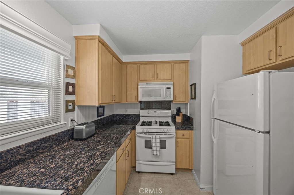 1763 Gleason Street Corona, CA 92882 - Photo 15 of 41 a kitchen with white cabinets and white appliances