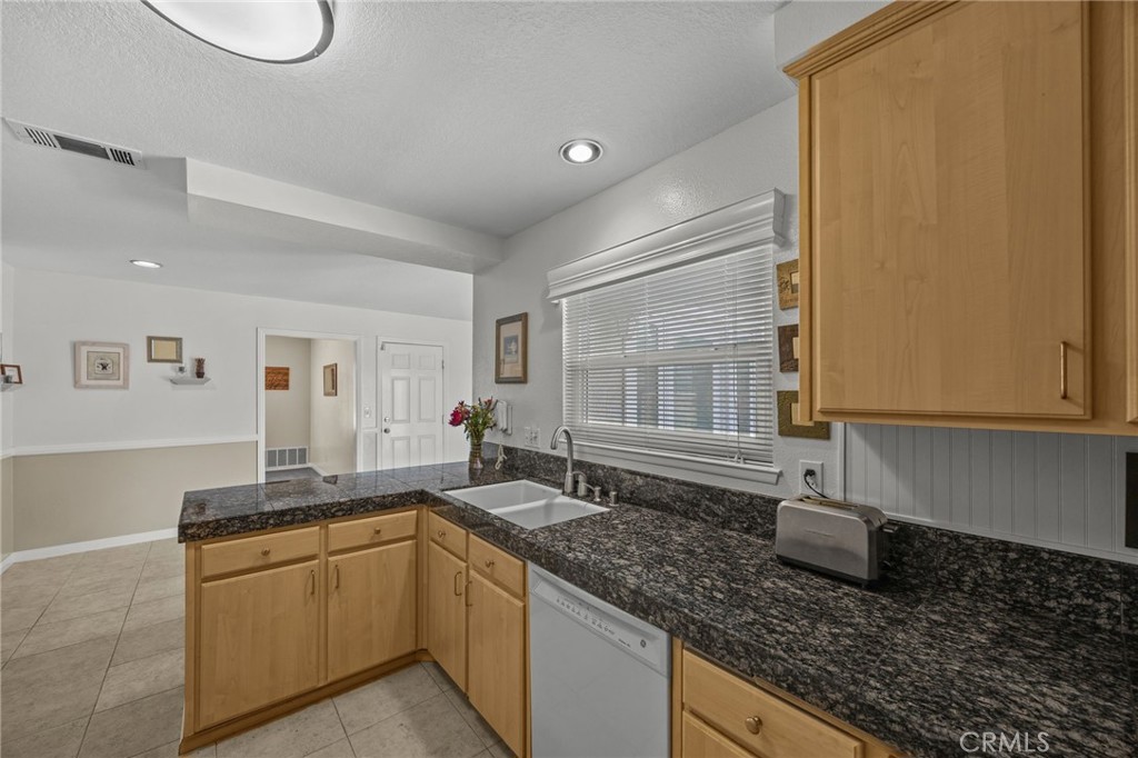 1763 Gleason Street Corona, CA 92882 - Photo 16 of 41 a kitchen with granite countertop a sink and a white cabinets